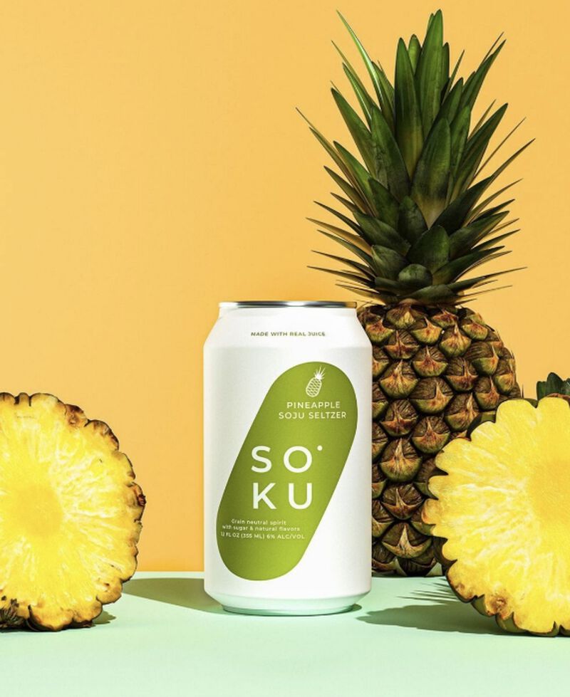 Can of Soku Pineapple Soju Cocktail with pineapples