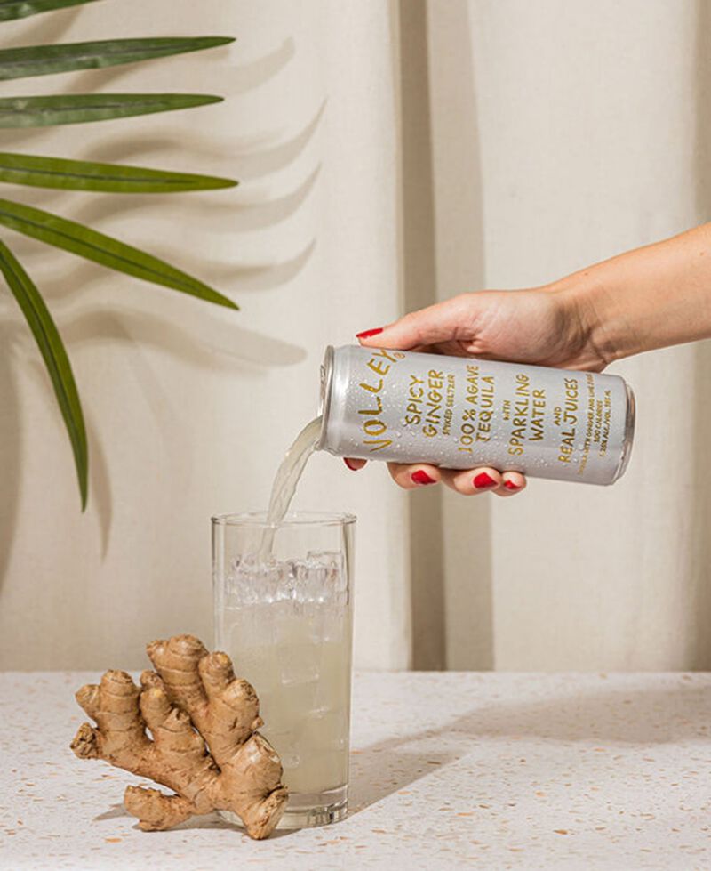 A can of Volley Spicy Ginger Tequila Seltzer being poured into a glass