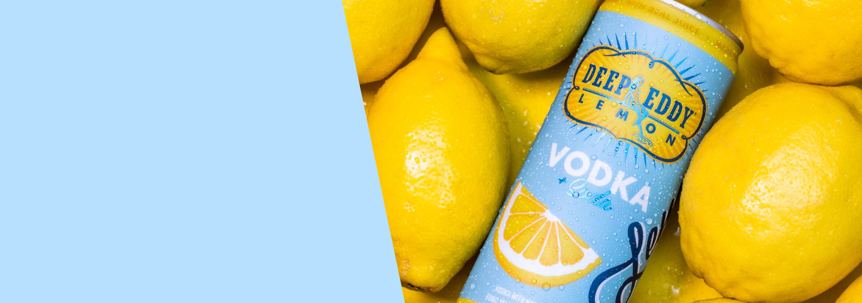 Can of Deep Eddy Lemon Vodka + Soda laying on lemons